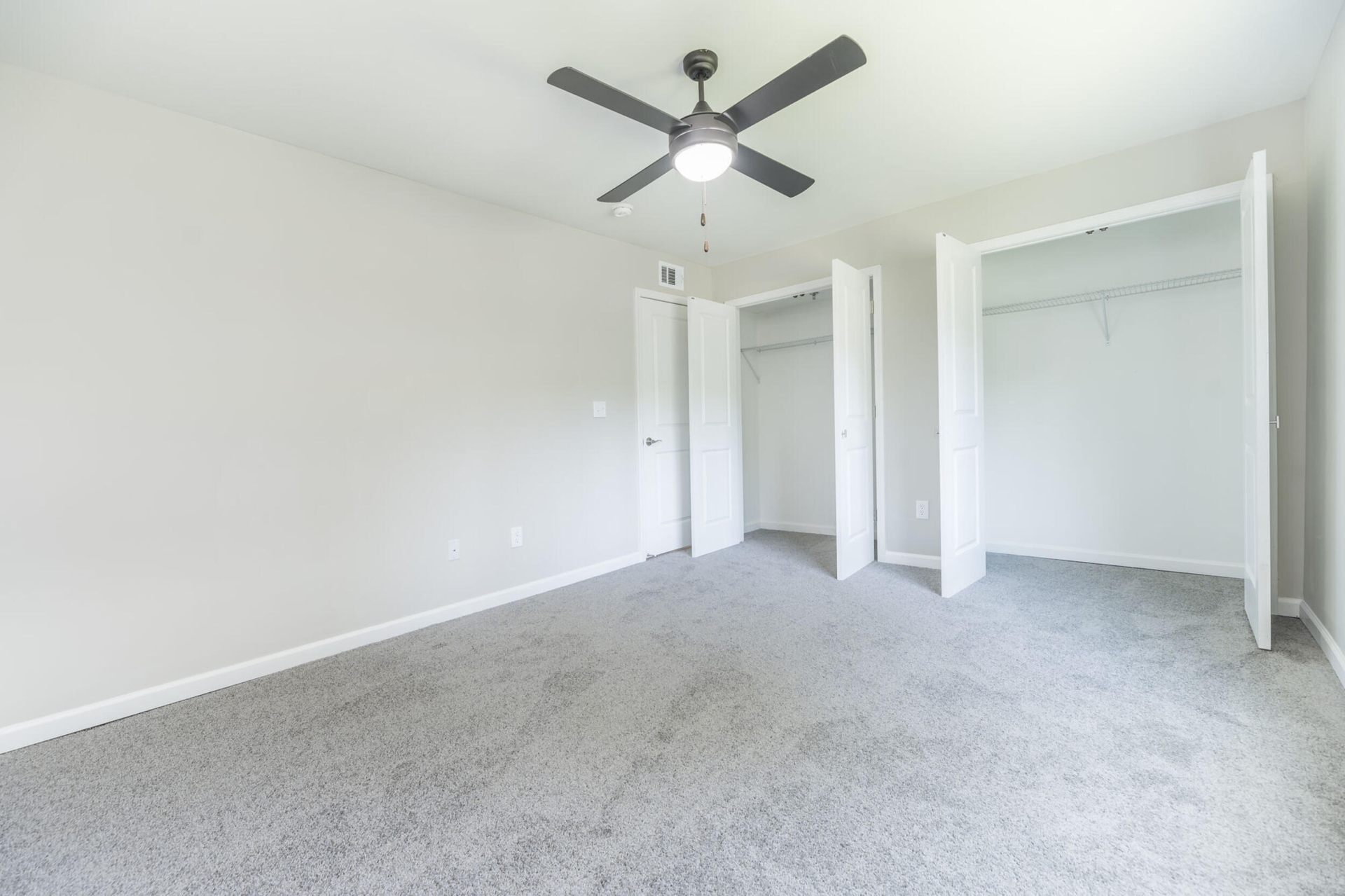 Rhythm at Riverdale apartments interior bedroom with two closets.